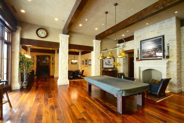 game room with pool table and fireplace